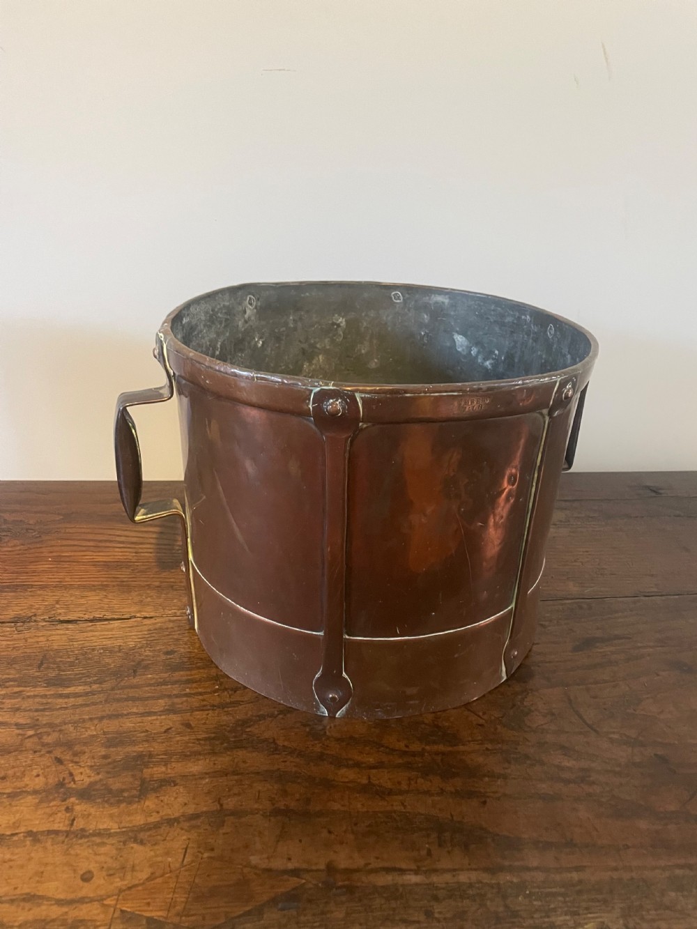 A 19th-century French cylindrical copper bucket featuring riveted vertical reinforcing bands, dual side handles, and a stamped makers mark. View VIII