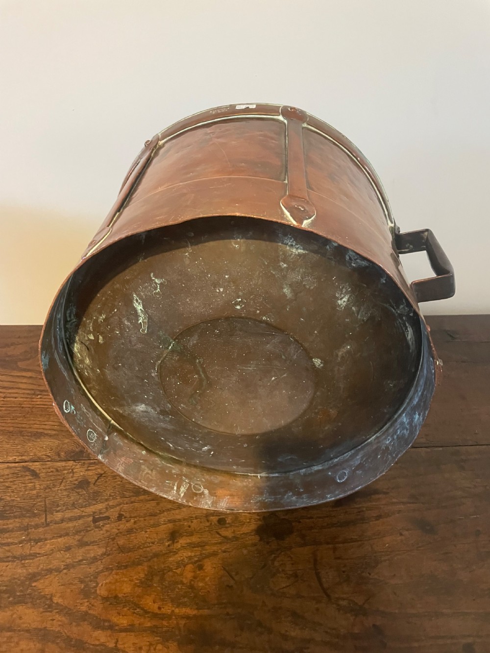 A 19th-century French cylindrical copper bucket featuring riveted vertical reinforcing bands, dual side handles, and a stamped makers mark. View X