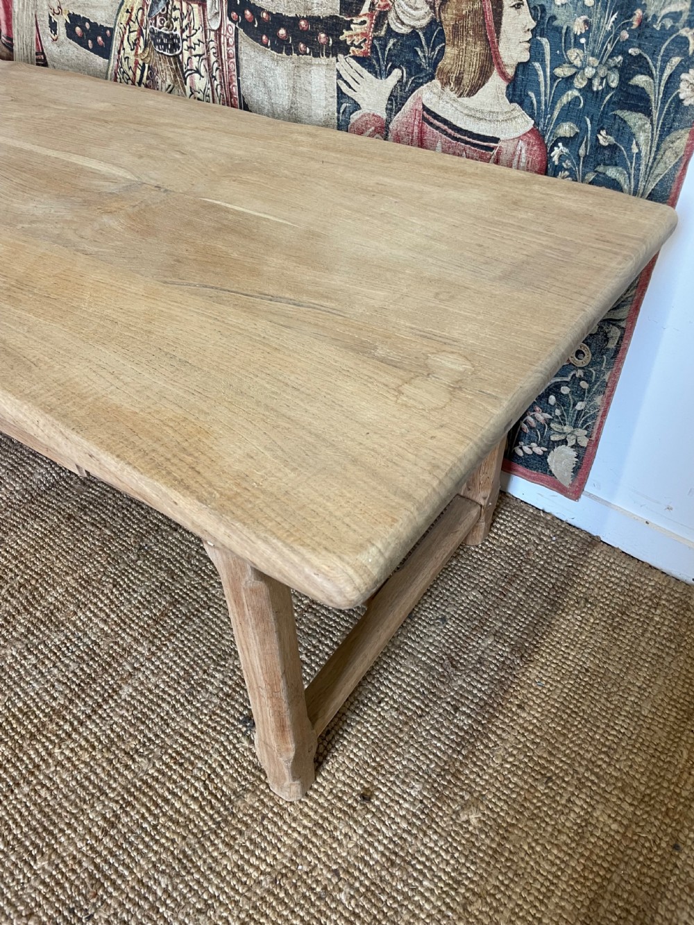A long light oak farmhouse table featuring a rectangular plank top, two frieze drawers with dark metal handles, and square legs joined by a low stretcher. View II