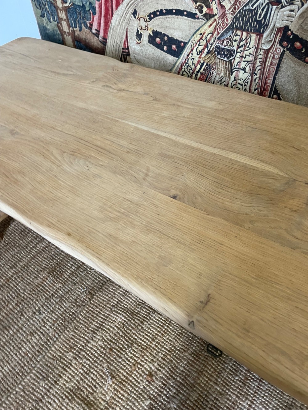 A long light oak farmhouse table featuring a rectangular plank top, two frieze drawers with dark metal handles, and square legs joined by a low stretcher. View VII