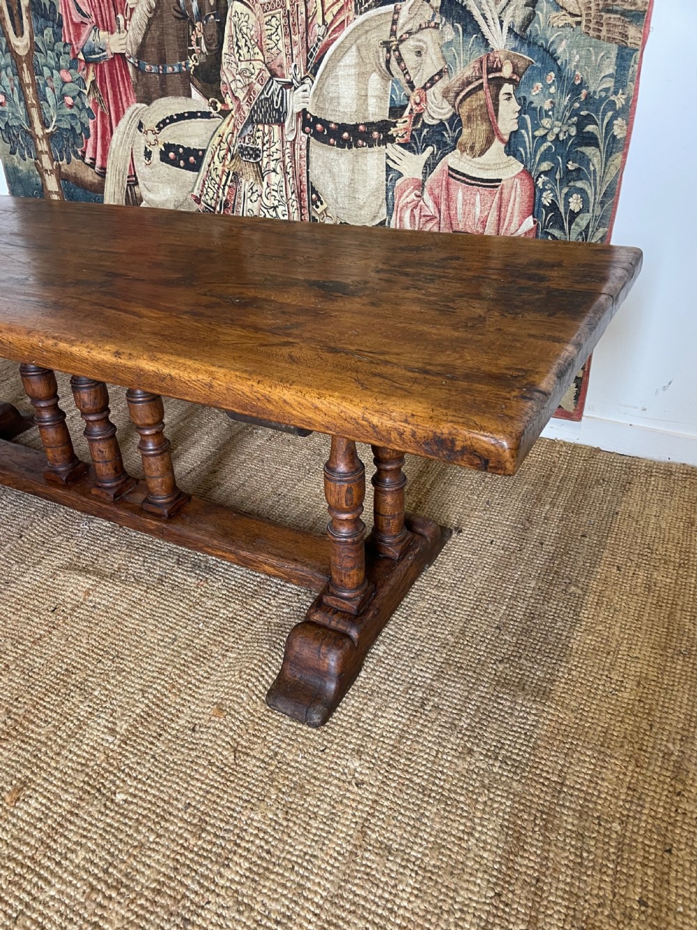 A long rectangular wooden refectory table featuring a plank top and turned leg supports joined by a low stretcher. View II