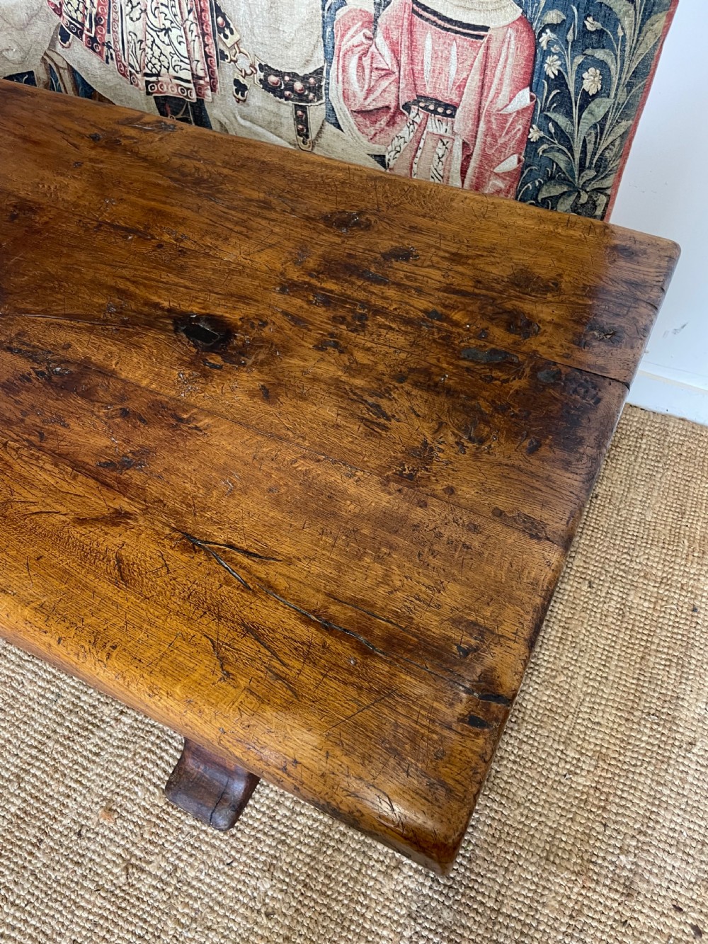 A long rectangular wooden refectory table featuring a plank top and turned leg supports joined by a low stretcher. View IV