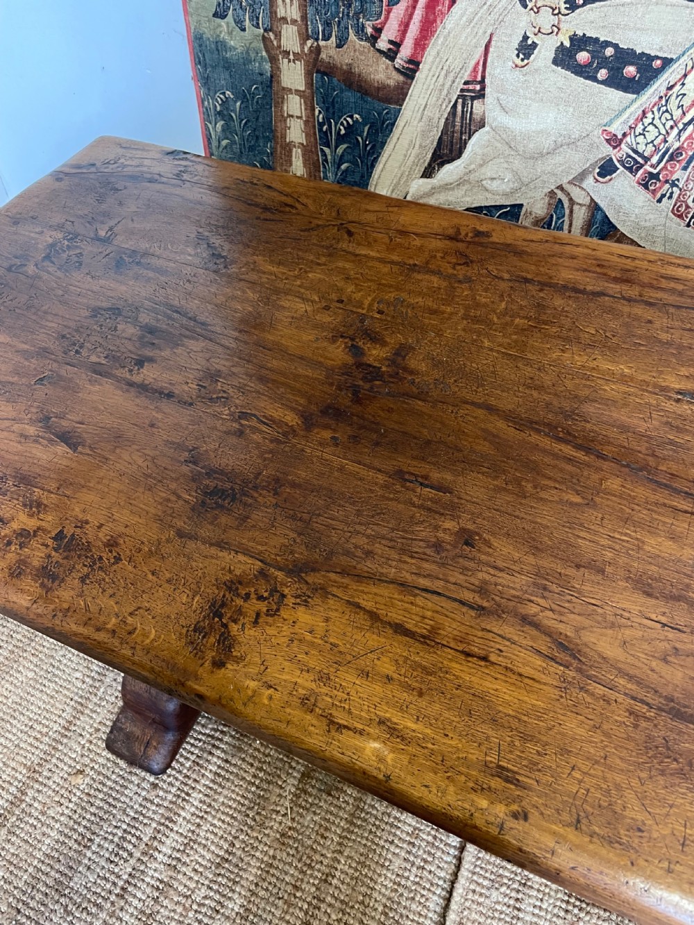 A long rectangular wooden refectory table featuring a plank top and turned leg supports joined by a low stretcher. View VII