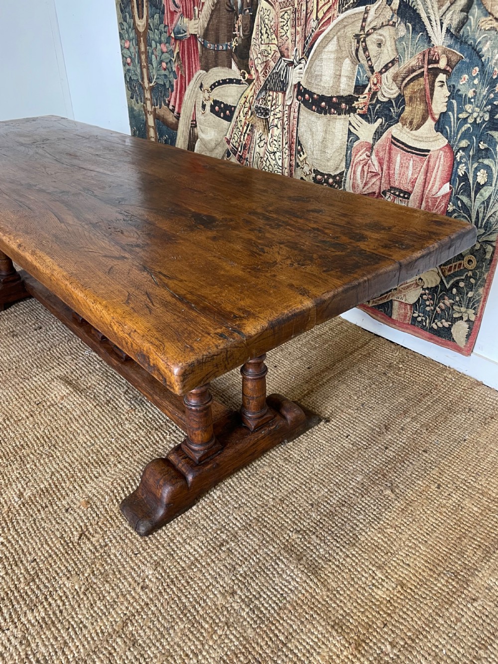 A long rectangular wooden refectory table featuring a plank top and turned leg supports joined by a low stretcher. View XIII