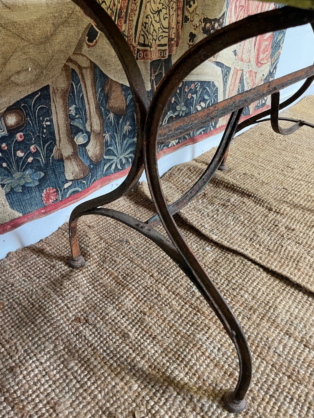 An antique rectangular metal garden table with a distressed yellow painted top and curved iron legs. View VIII