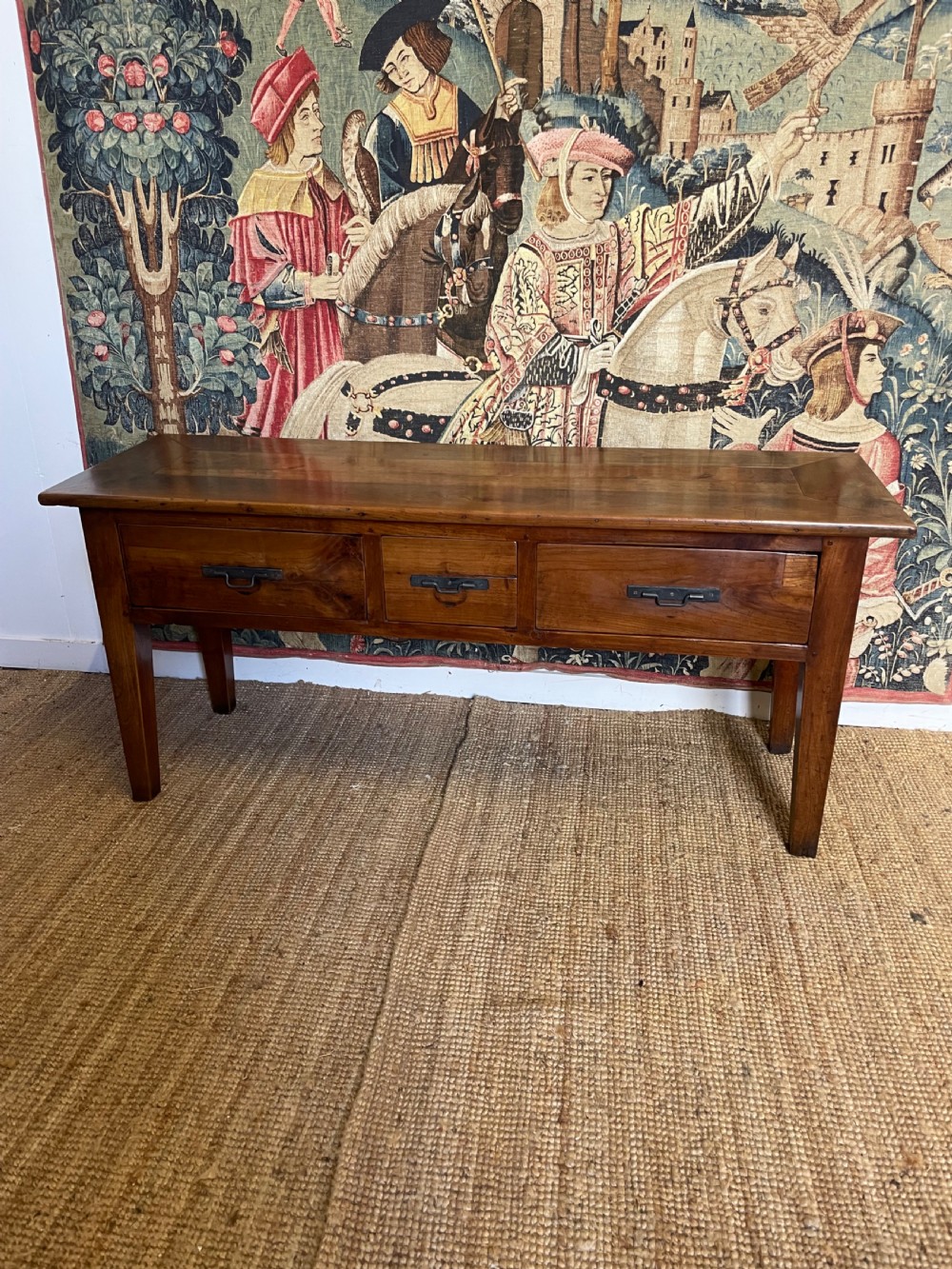 A rectangular cherrywood dresser base featuring three drawers with metal drop handles and straight tapered legs.