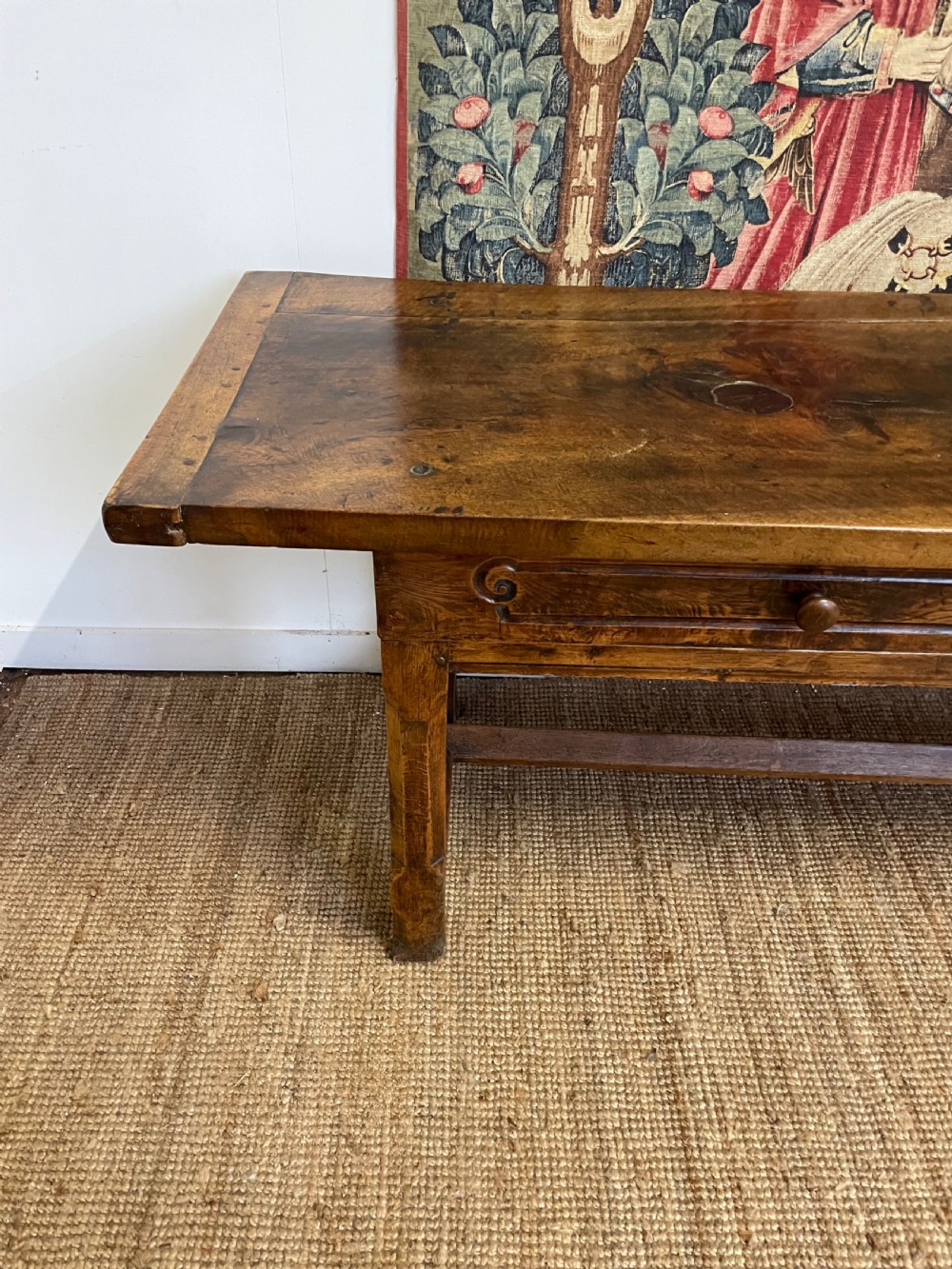 An elongated antique walnut console table featuring three drawers with brass hardware and low stretcher supports. View VIII