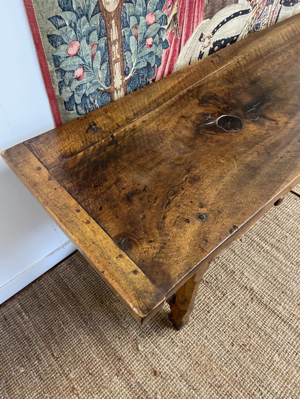 An elongated antique walnut console table featuring three drawers with brass hardware and low stretcher supports. View XIV