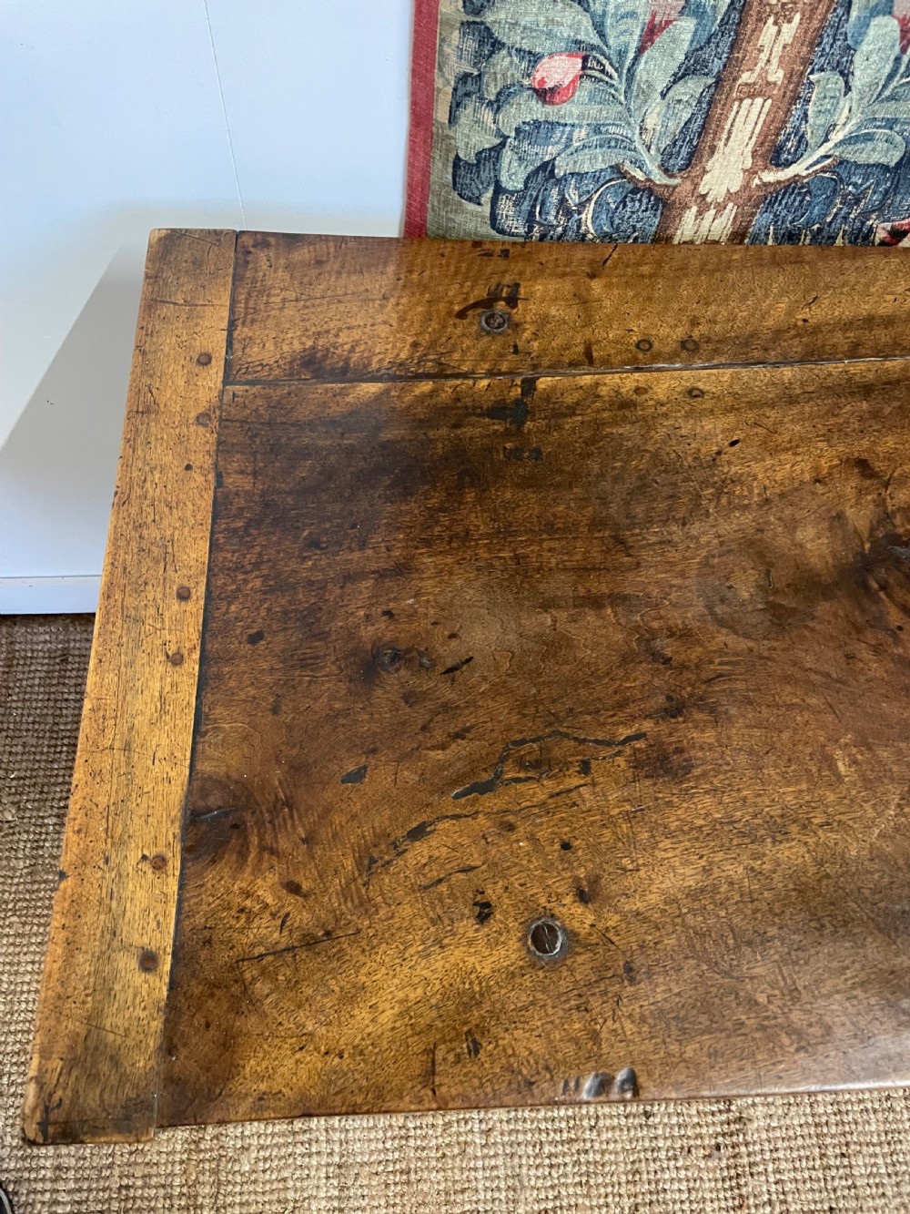 An elongated antique walnut console table featuring three drawers with brass hardware and low stretcher supports. View XVI