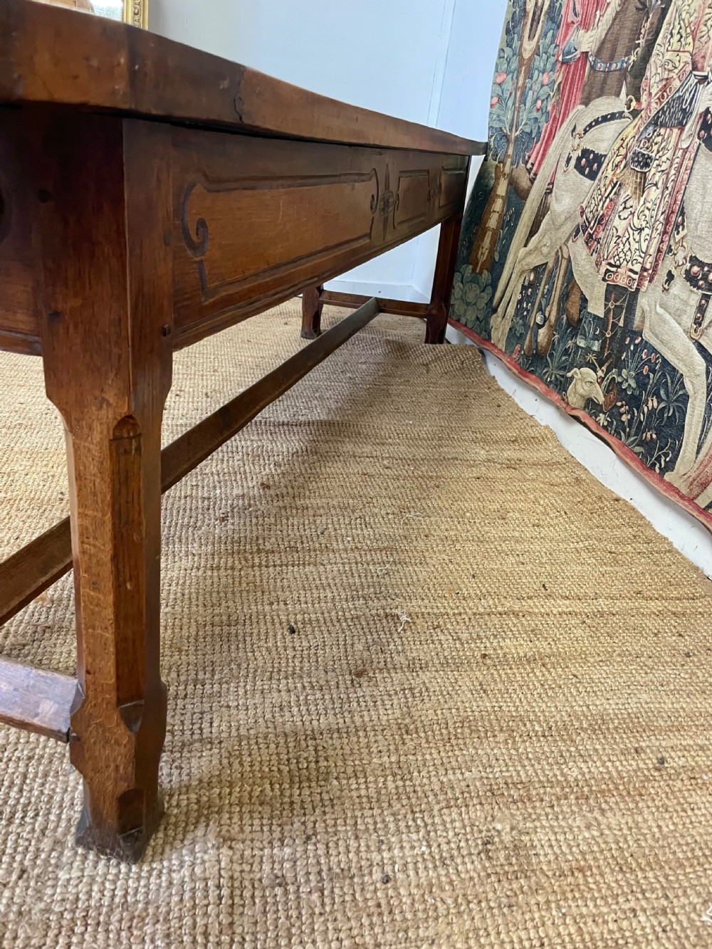 An elongated antique walnut console table featuring three drawers with brass hardware and low stretcher supports. View XVIII