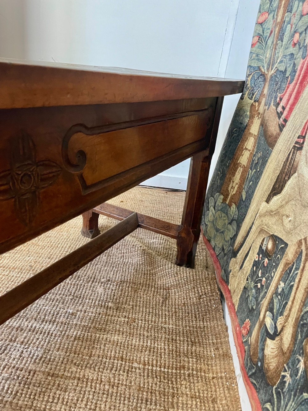 An elongated antique walnut console table featuring three drawers with brass hardware and low stretcher supports. View XIX