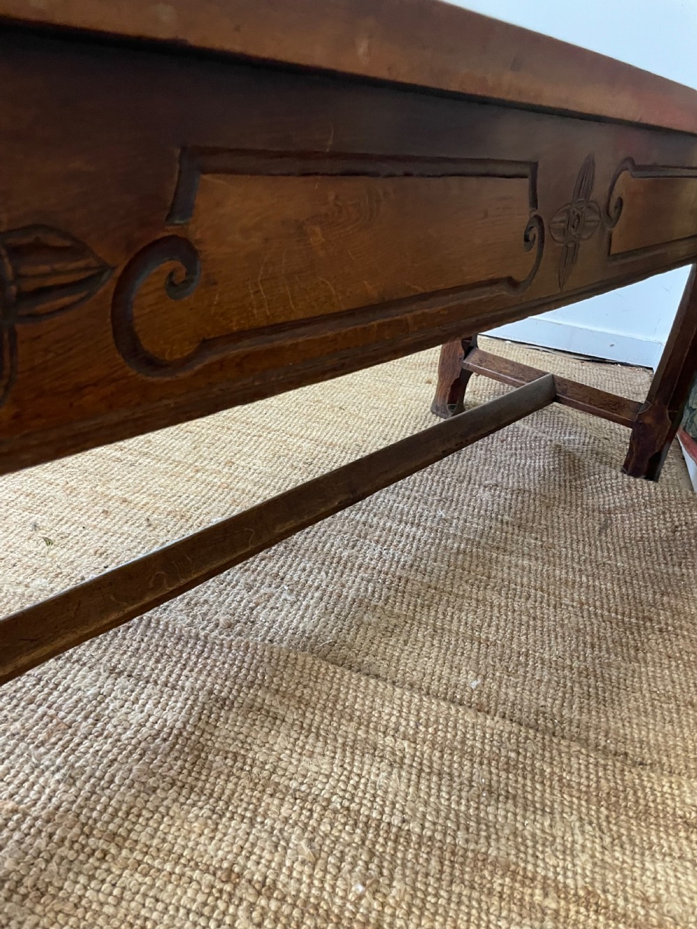 An elongated antique walnut console table featuring three drawers with brass hardware and low stretcher supports. View XX