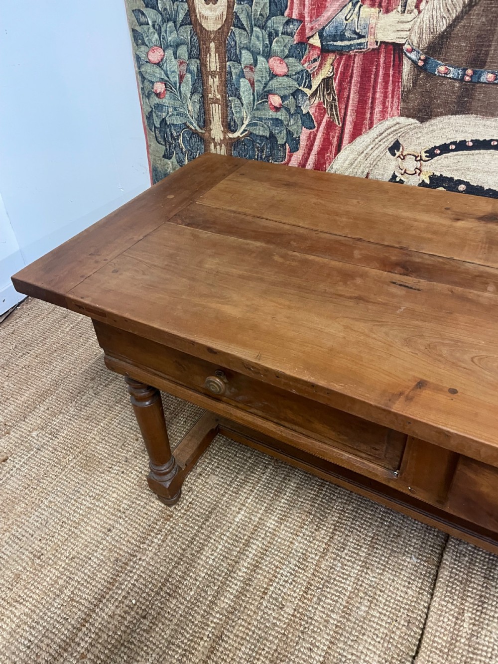 A long rectangular antique cherrywood console table featuring three frieze drawers with small brass knobs and turned legs connected by a low stretcher. View VIII