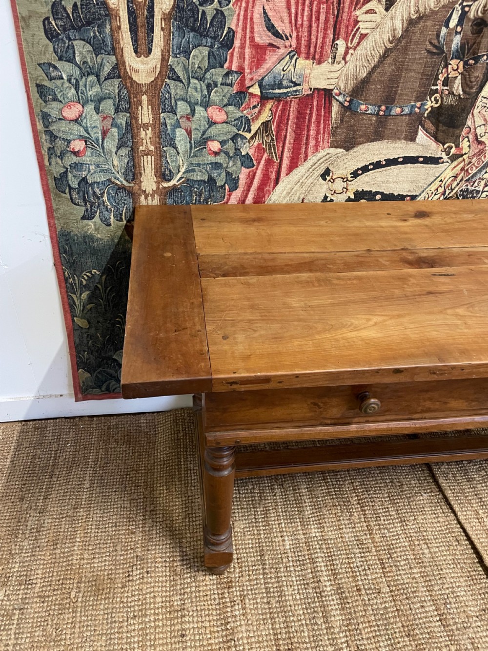 A long rectangular antique cherrywood console table featuring three frieze drawers with small brass knobs and turned legs connected by a low stretcher. View IX