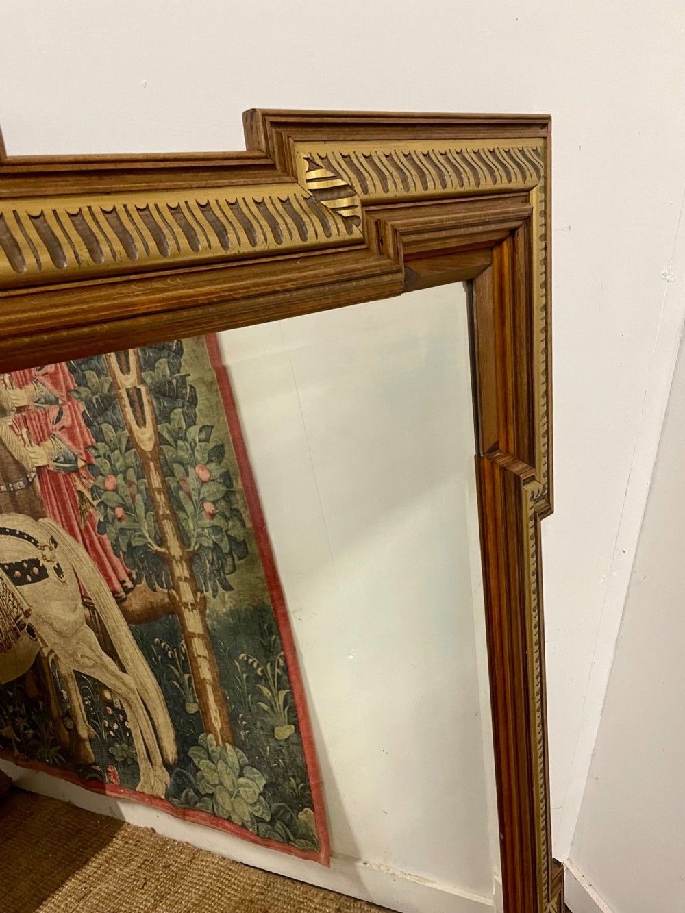 A rectangular walnut wall mirror featuring stepped architectural corner mouldings and carved parcel gilt accent trim. View III