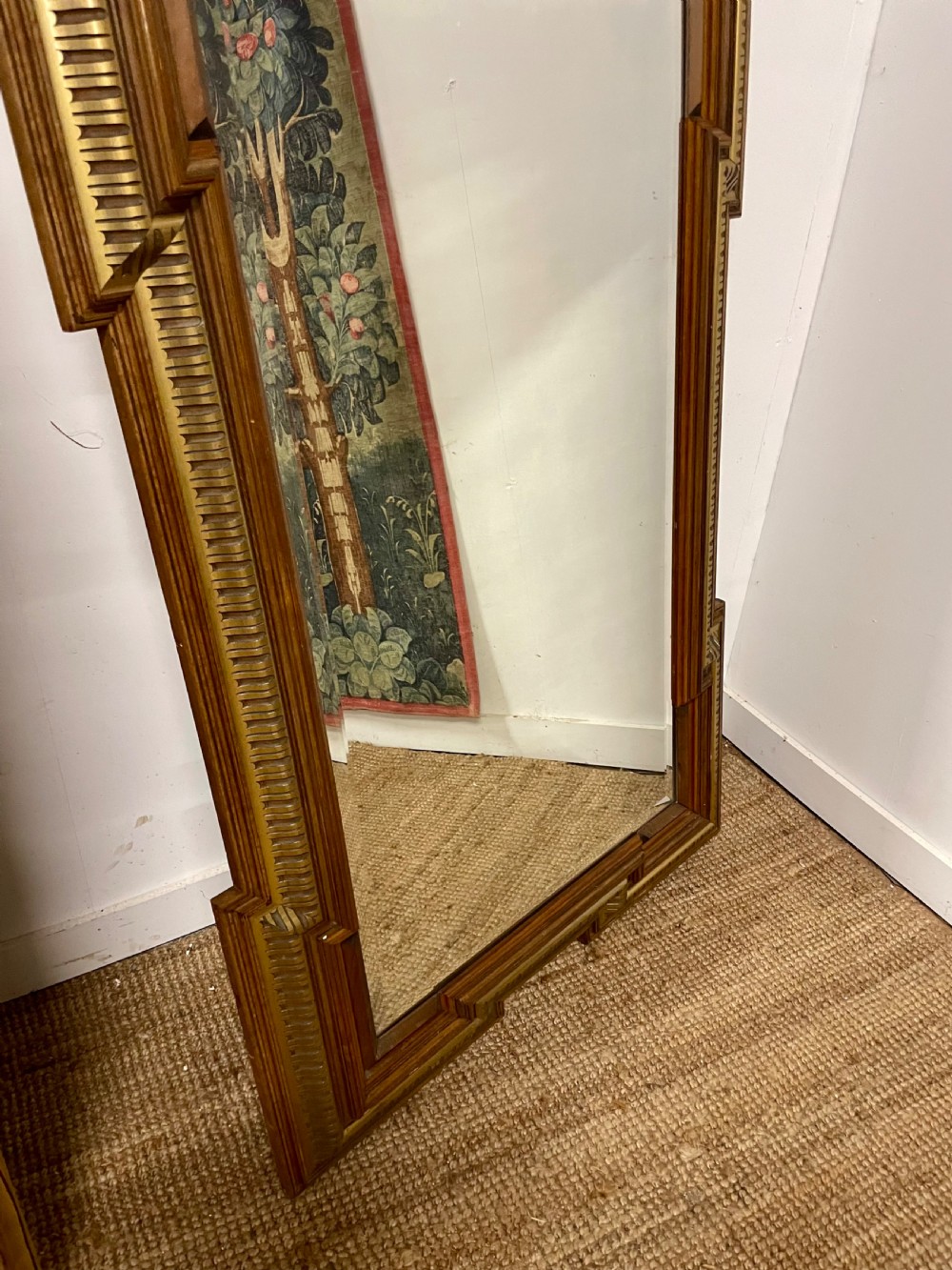 A rectangular walnut wall mirror featuring stepped architectural corner mouldings and carved parcel gilt accent trim. View IV