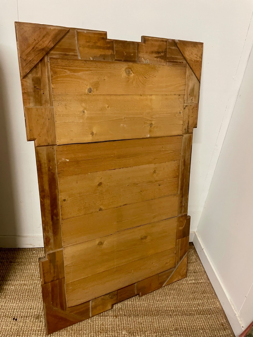 A rectangular walnut wall mirror featuring stepped architectural corner mouldings and carved parcel gilt accent trim. View VIII