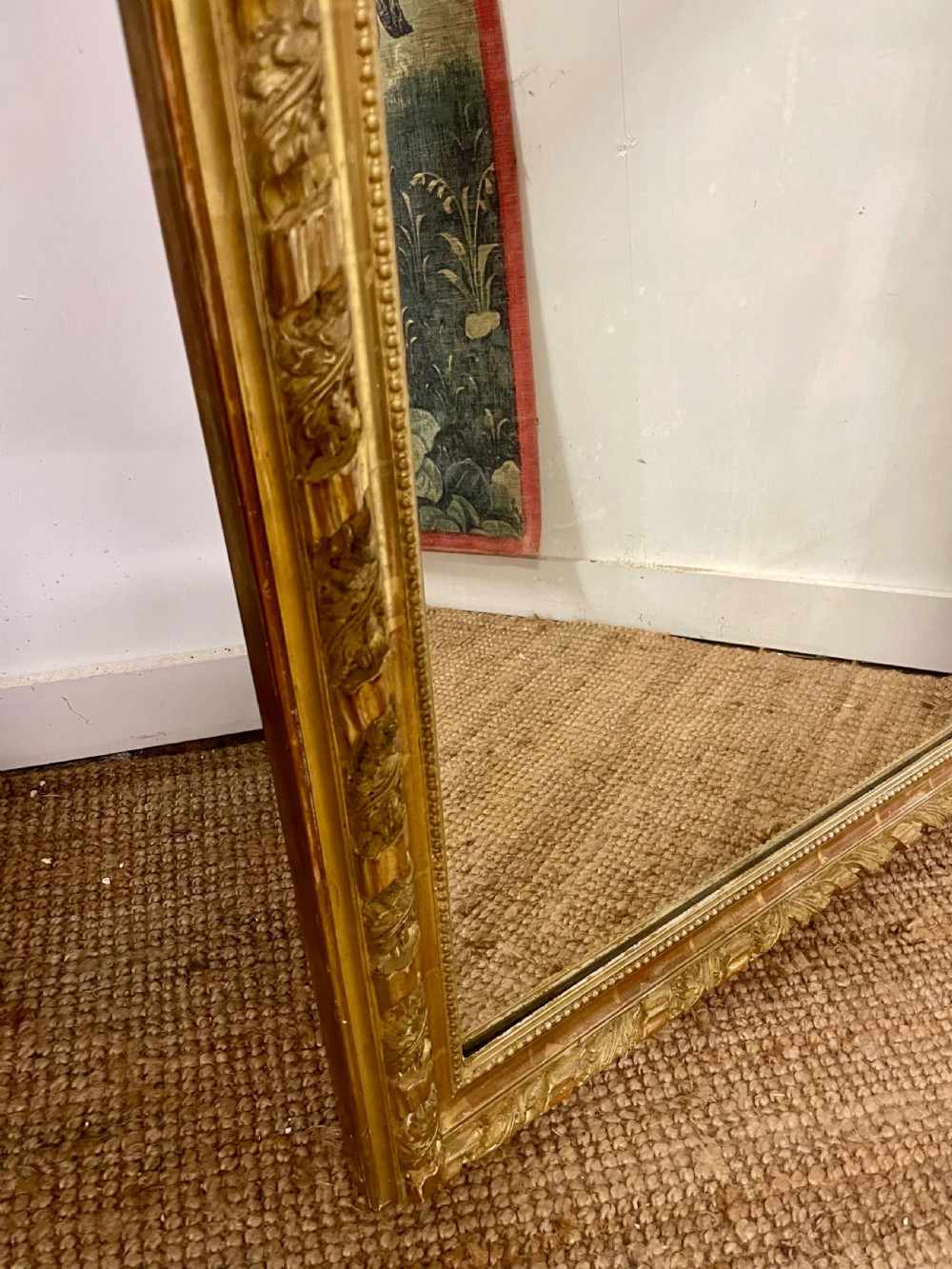 A late nineteenth-century gilded wall mirror featuring an arched top, carved shell cresting, and foliate moulding on the frame. View VII