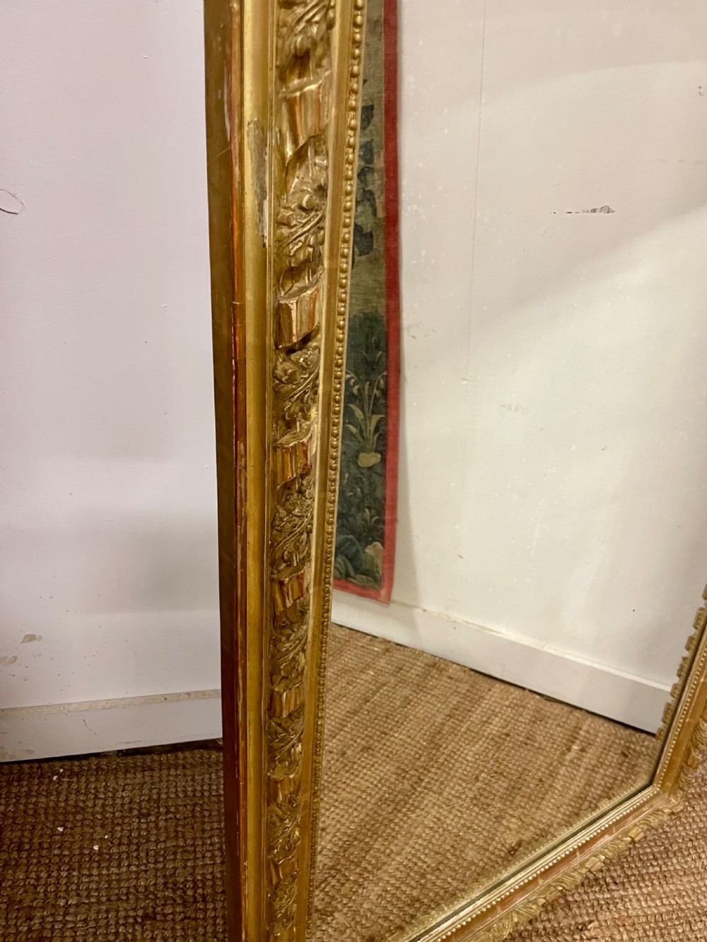 A late nineteenth-century gilded wall mirror featuring an arched top, carved shell cresting, and foliate moulding on the frame. View VIII