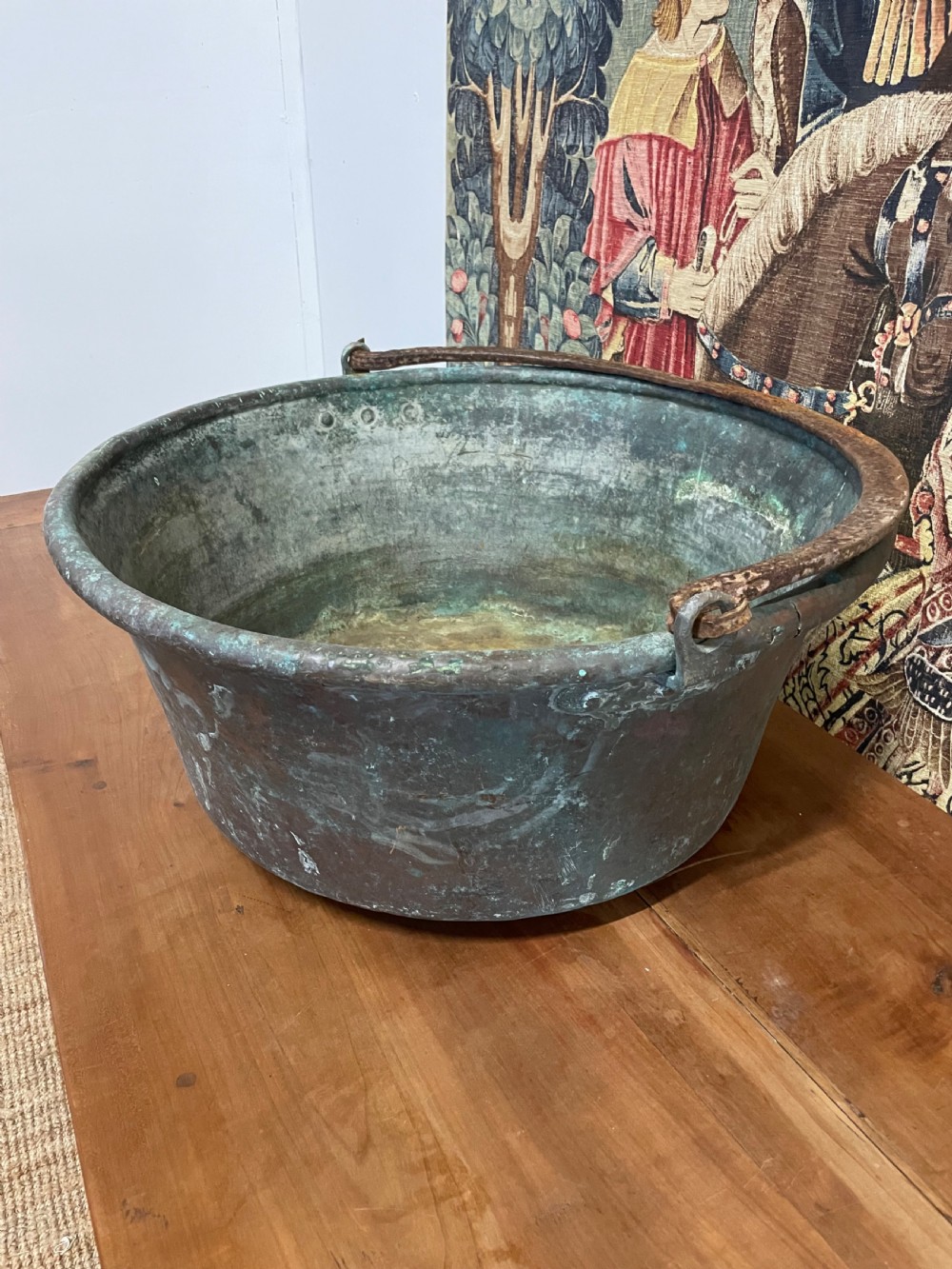 A 19th-century round copper log bin featuring a natural green verdigris patina and a heavy wrought iron swing handle. View III