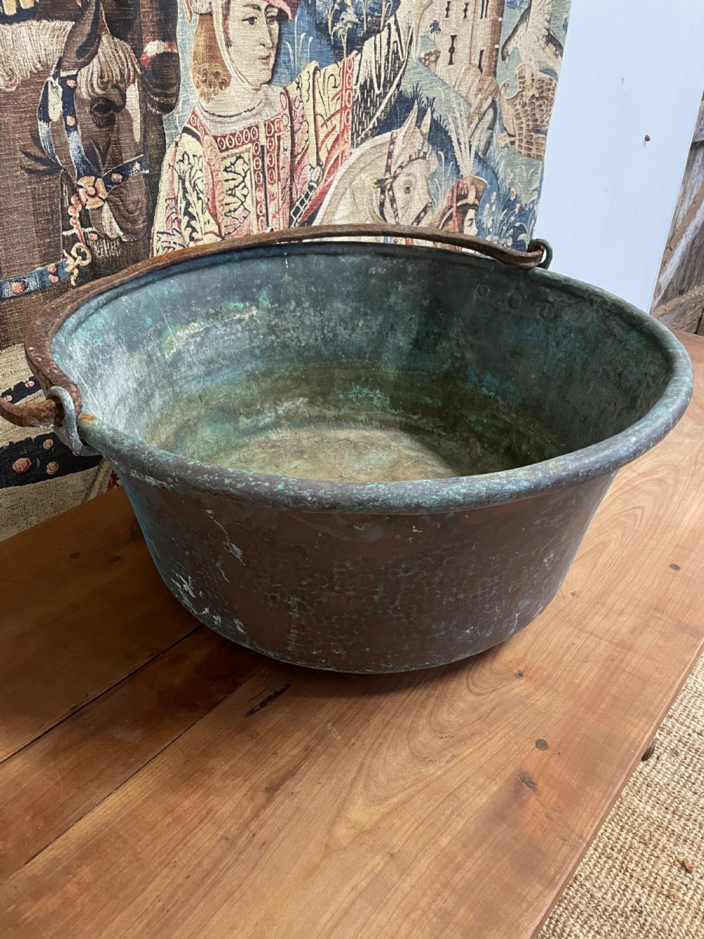 A 19th-century round copper log bin featuring a natural green verdigris patina and a heavy wrought iron swing handle. View V