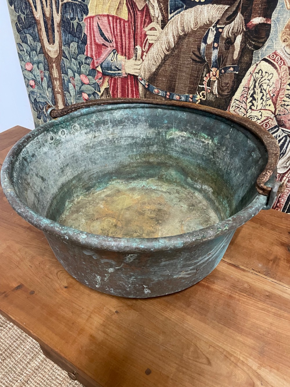 A 19th-century round copper log bin featuring a natural green verdigris patina and a heavy wrought iron swing handle. View VI