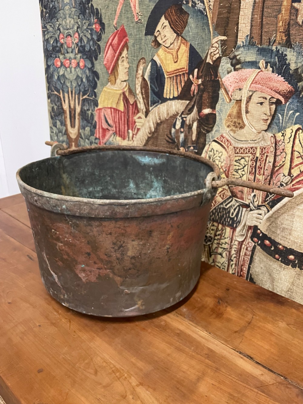 A circular 19th-century copper vessel with a verdigris interior, patinated copper exterior, rolled rim, and wrought iron side handles. View II