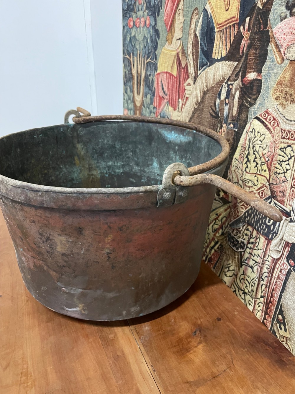 A circular 19th-century copper vessel with a verdigris interior, patinated copper exterior, rolled rim, and wrought iron side handles. View III