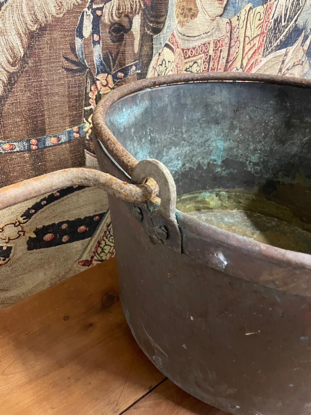 A circular 19th-century copper vessel with a verdigris interior, patinated copper exterior, rolled rim, and wrought iron side handles. View VI