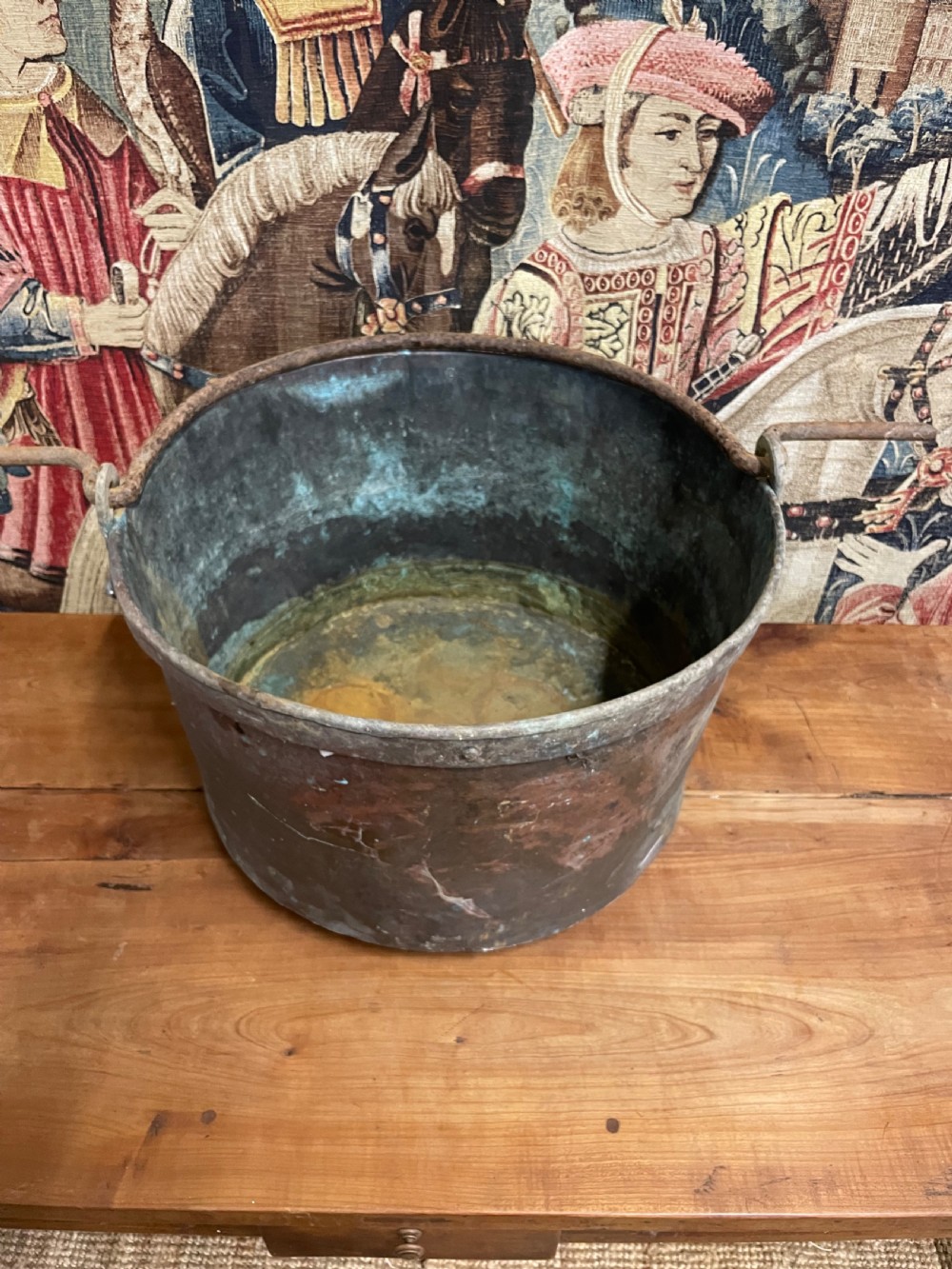 A circular 19th-century copper vessel with a verdigris interior, patinated copper exterior, rolled rim, and wrought iron side handles. View VII