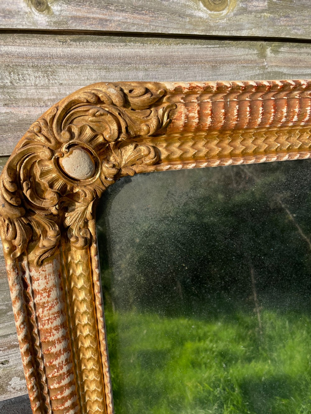 A 19th-century rectangular wall mirror featuring an arched upper frame with detailed giltwood moulding, corner cartouches, and patinated mirror glass. View III