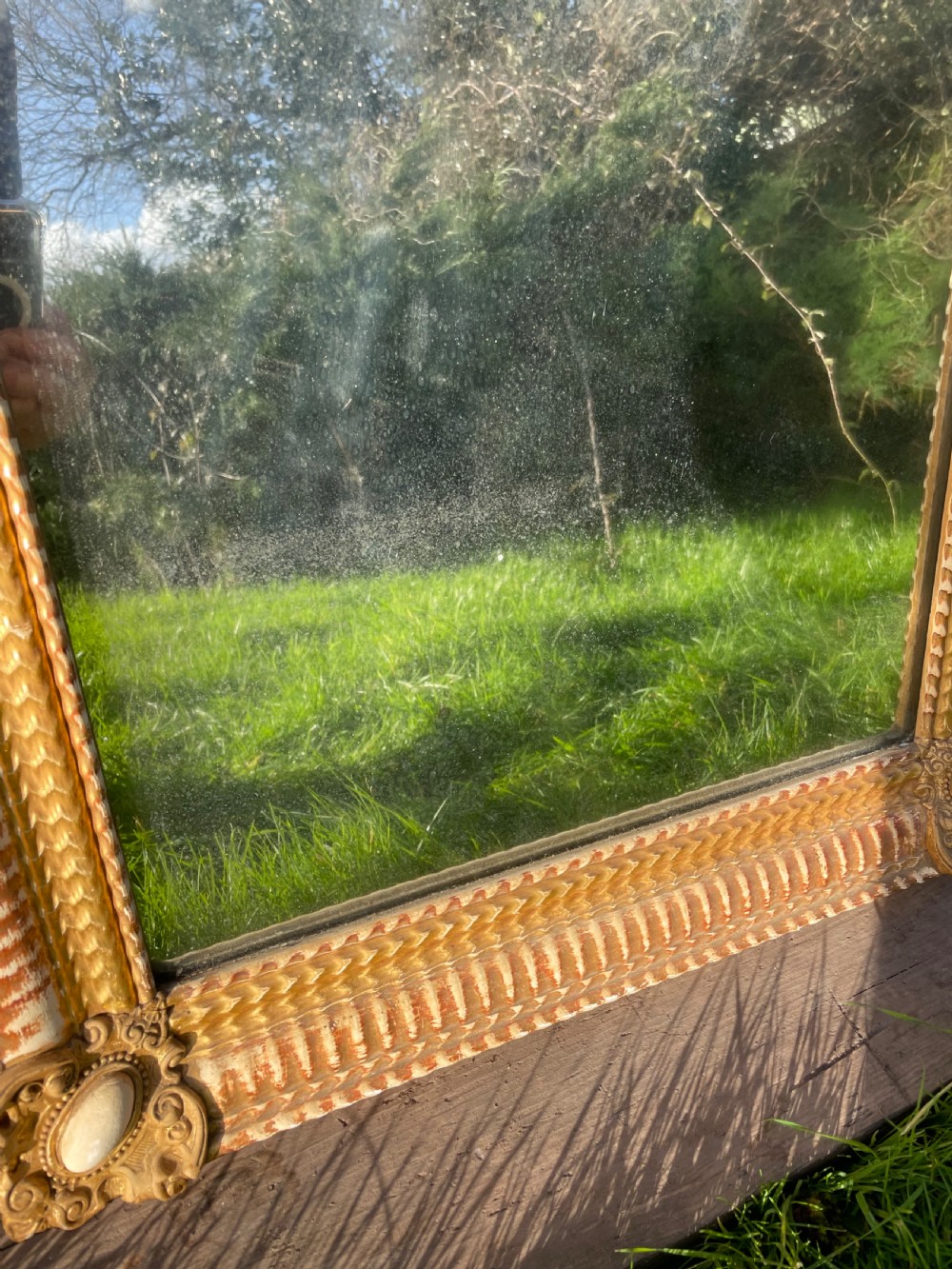 A 19th-century rectangular wall mirror featuring an arched upper frame with detailed giltwood moulding, corner cartouches, and patinated mirror glass. View VIII