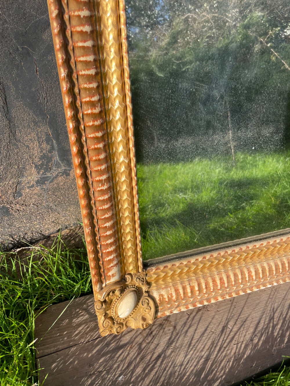 A 19th-century rectangular wall mirror featuring an arched upper frame with detailed giltwood moulding, corner cartouches, and patinated mirror glass. View IX