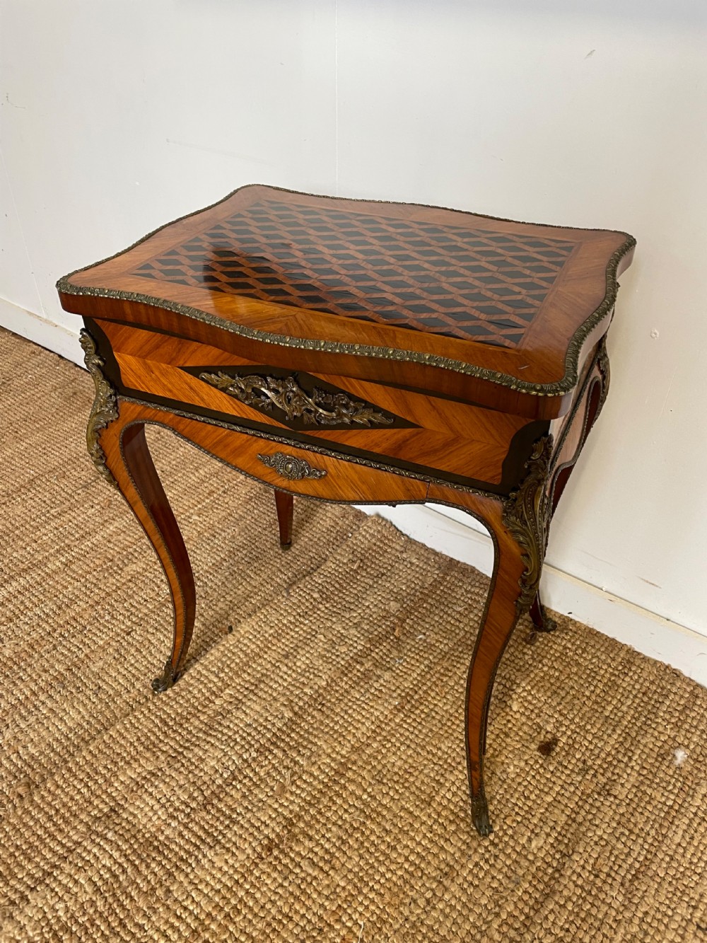 A 19th-century French Napoleon III kingwood worktable featuring parquetry top surface, serpentine cabriole legs, and cast brass mounts. View III