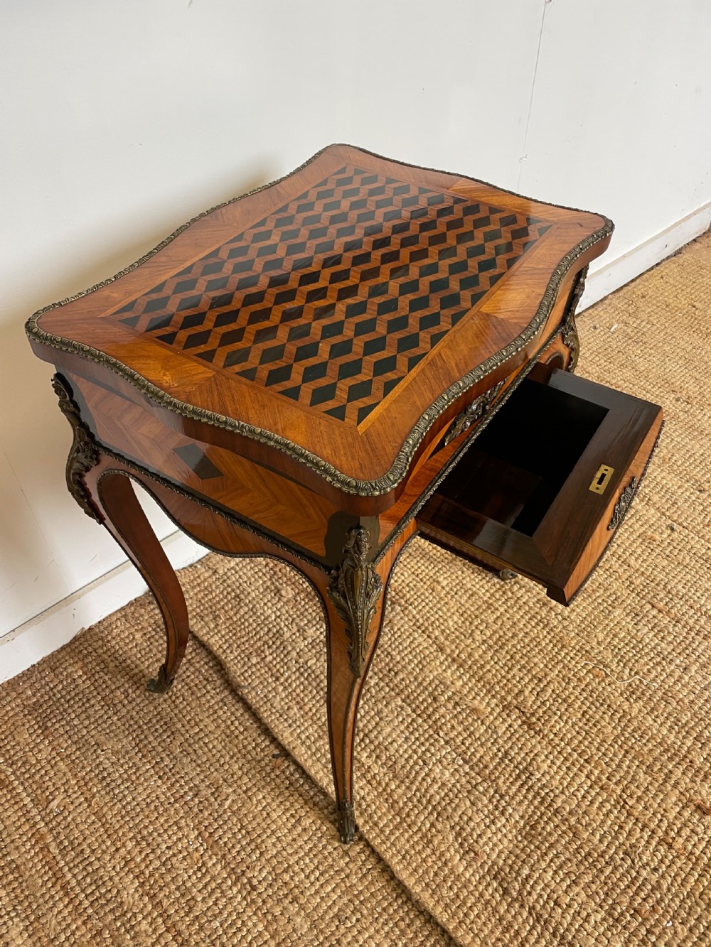 A 19th-century French Napoleon III kingwood worktable featuring parquetry top surface, serpentine cabriole legs, and cast brass mounts. View V