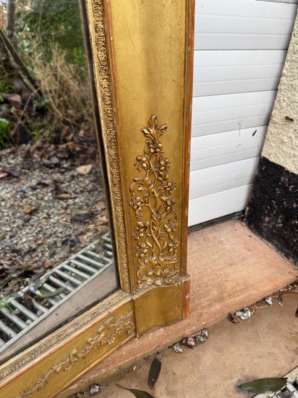 A large rectangular early 19th-century Empire style overmantel mirror featuring a gilded frame with ornate floral moulding. View II