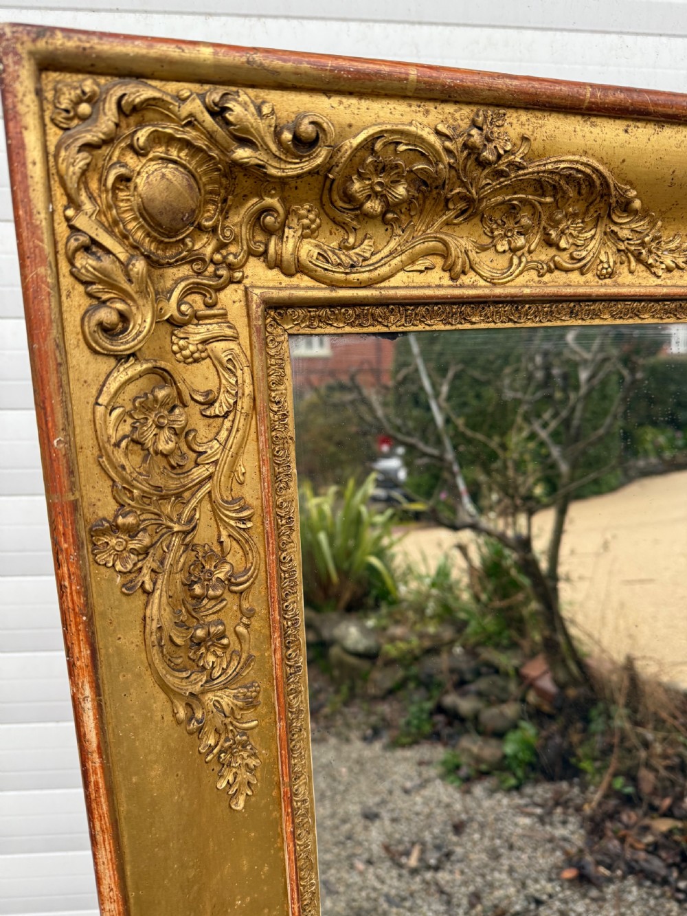 A large rectangular early 19th-century Empire style overmantel mirror featuring a gilded frame with ornate floral moulding. View III