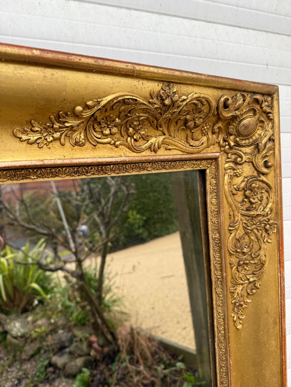 A large rectangular early 19th-century Empire style overmantel mirror featuring a gilded frame with ornate floral moulding. View V