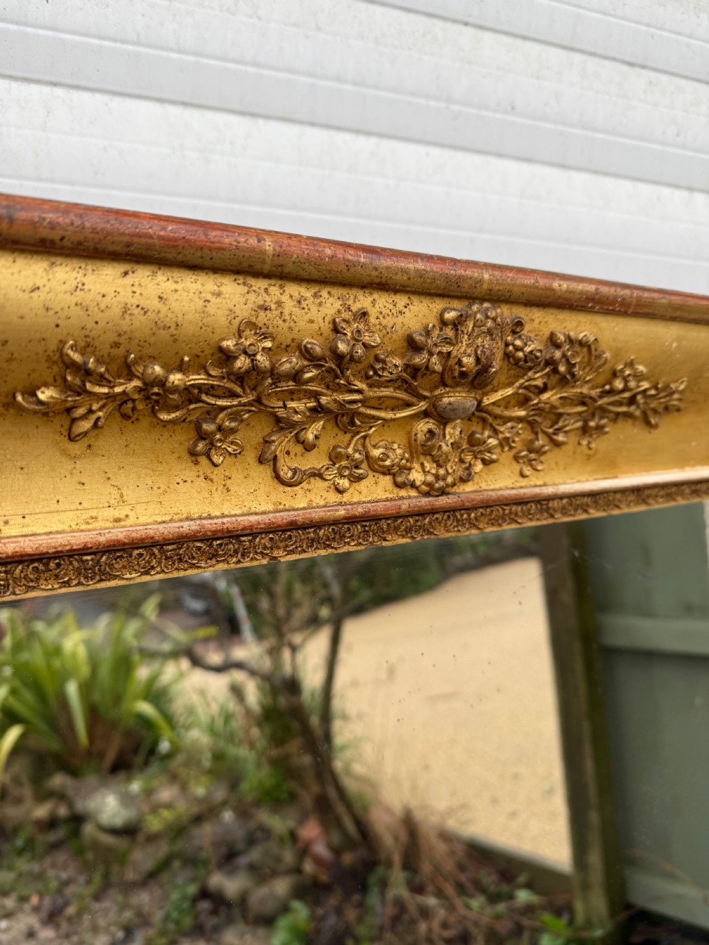 A large rectangular early 19th-century Empire style overmantel mirror featuring a gilded frame with ornate floral moulding. View X