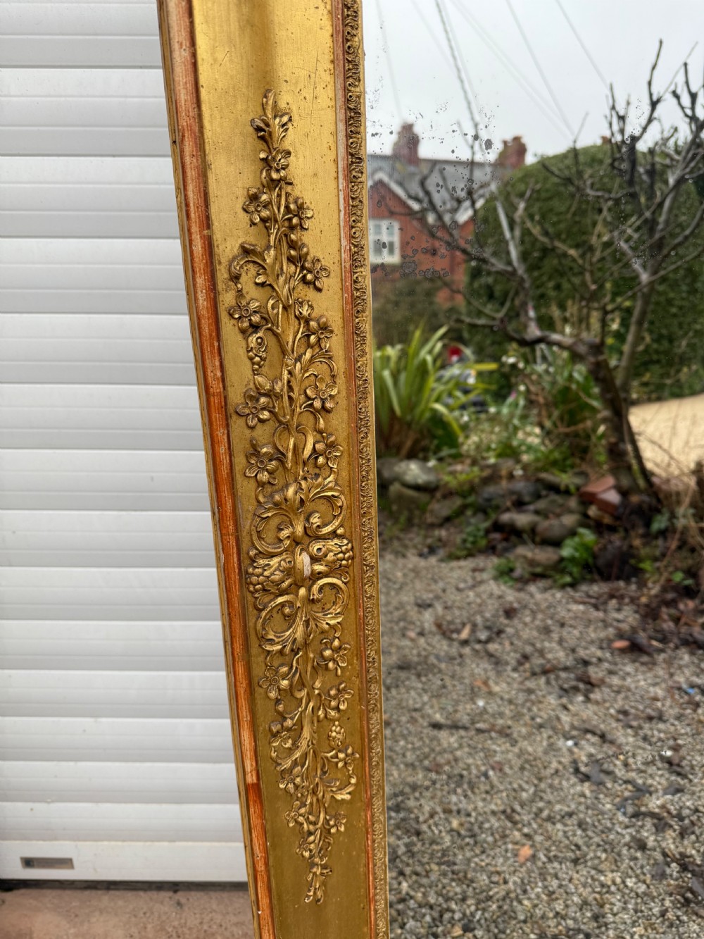 A large rectangular early 19th-century Empire style overmantel mirror featuring a gilded frame with ornate floral moulding. View XI