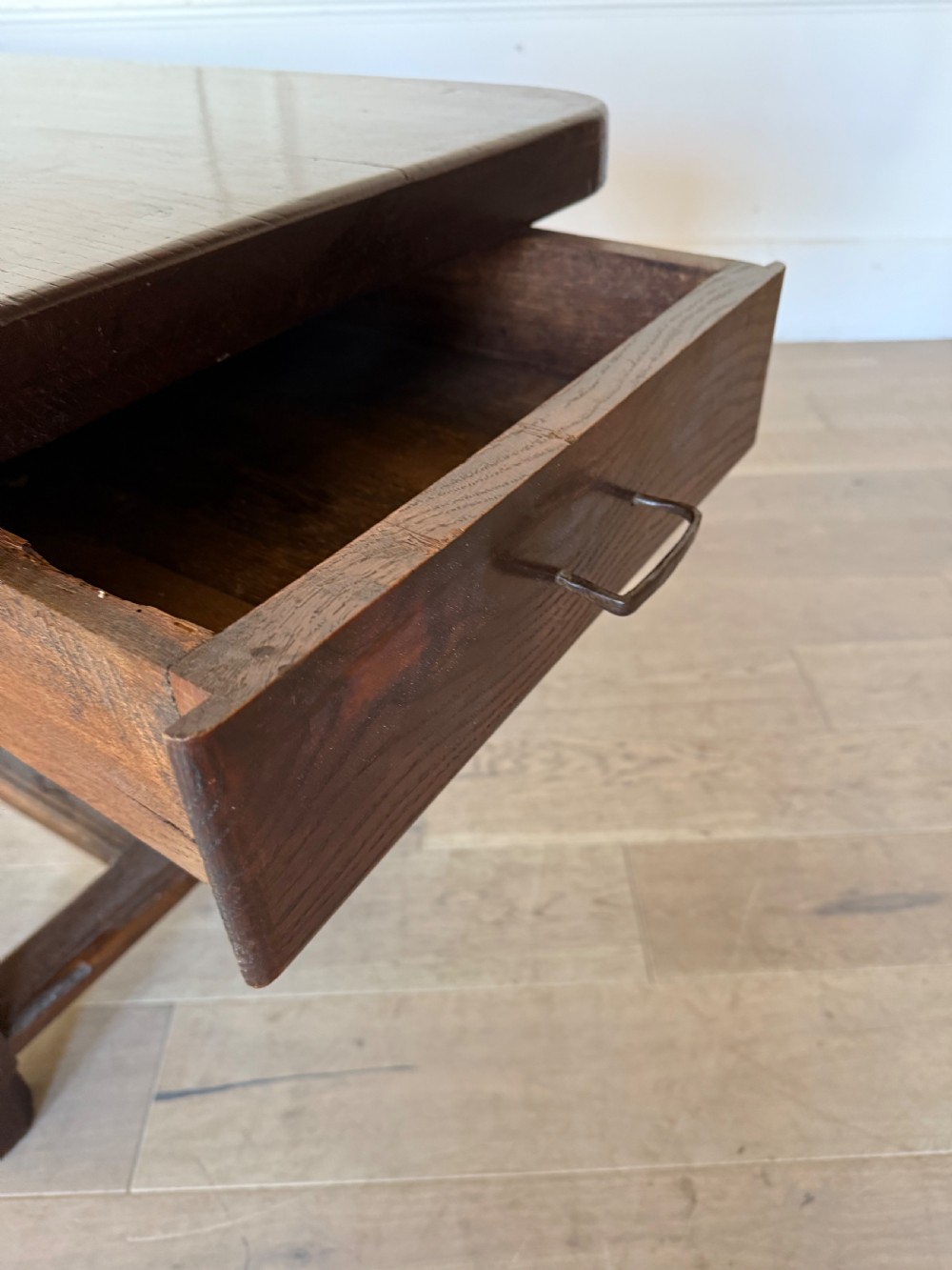An eighteenth century oak console table with a rectangular plank top and a shaped frieze above plain stretcher-joined legs. View XIII