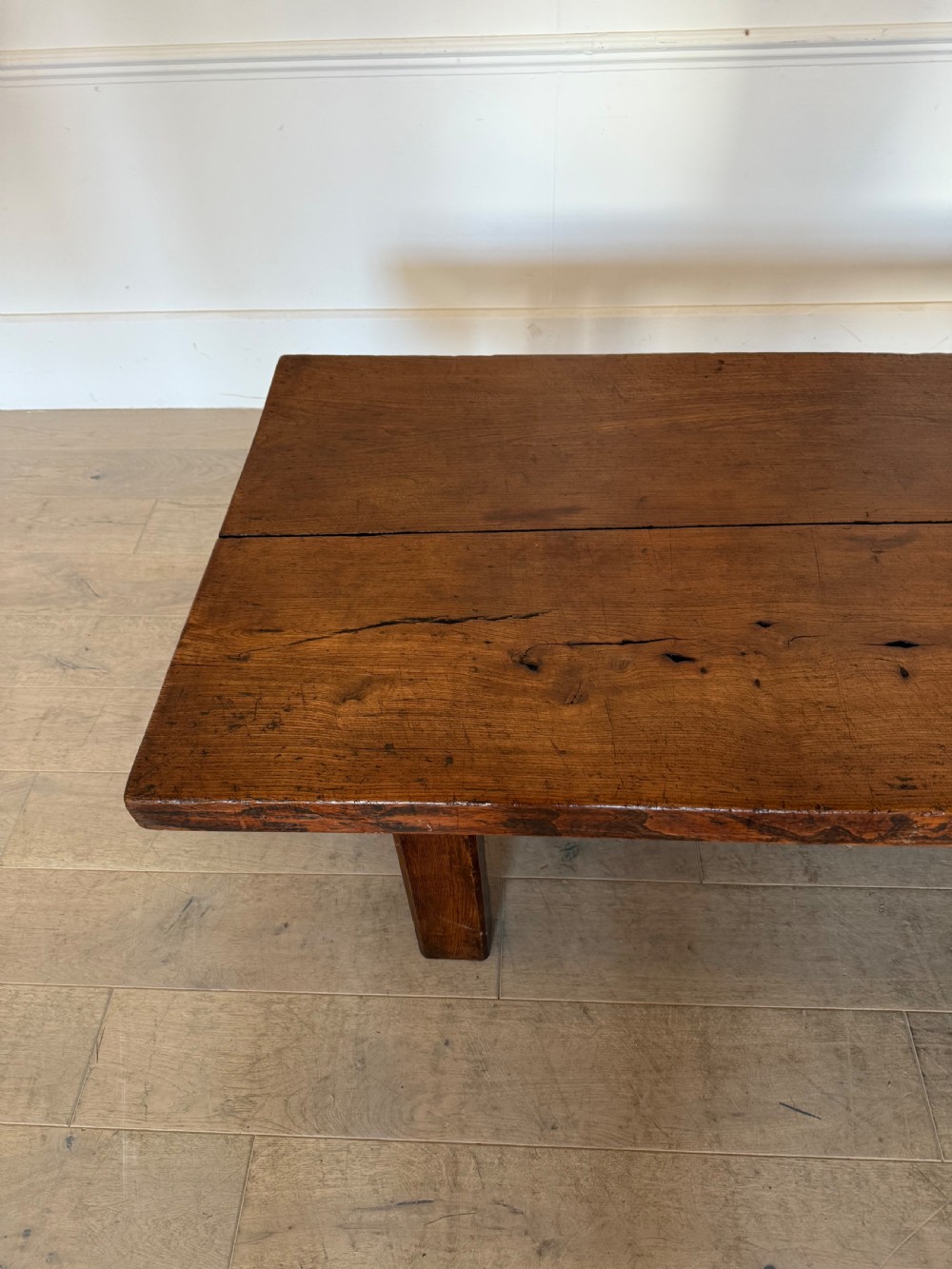 A large rectangular 19th-century elm coffee table with a two-plank top and sturdy wooden legs. View II