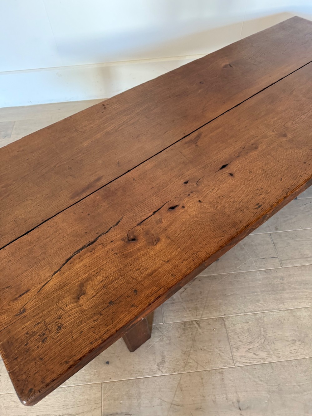 A large rectangular 19th-century elm coffee table with a two-plank top and sturdy wooden legs. View VI