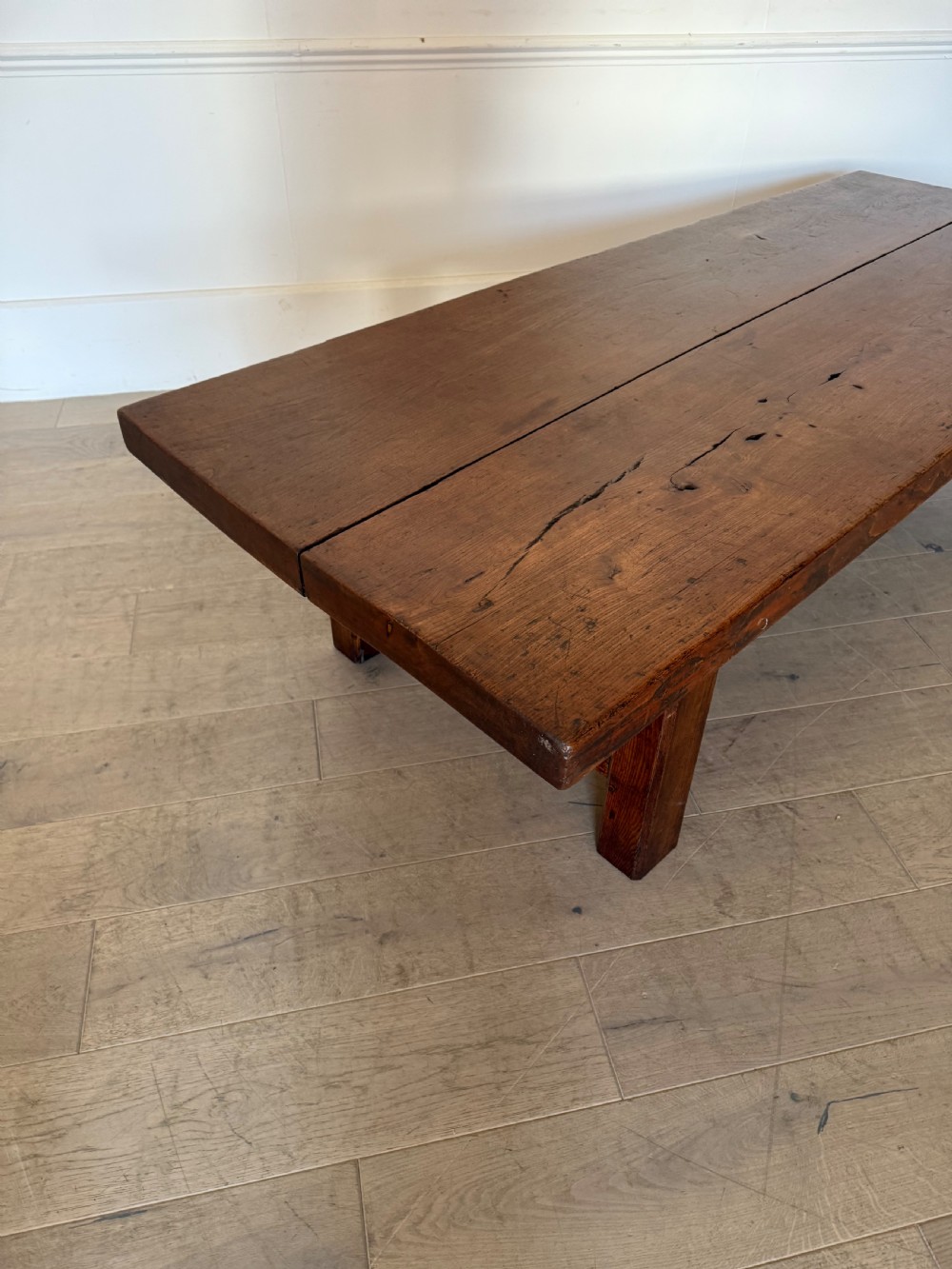 A large rectangular 19th-century elm coffee table with a two-plank top and sturdy wooden legs. View VII