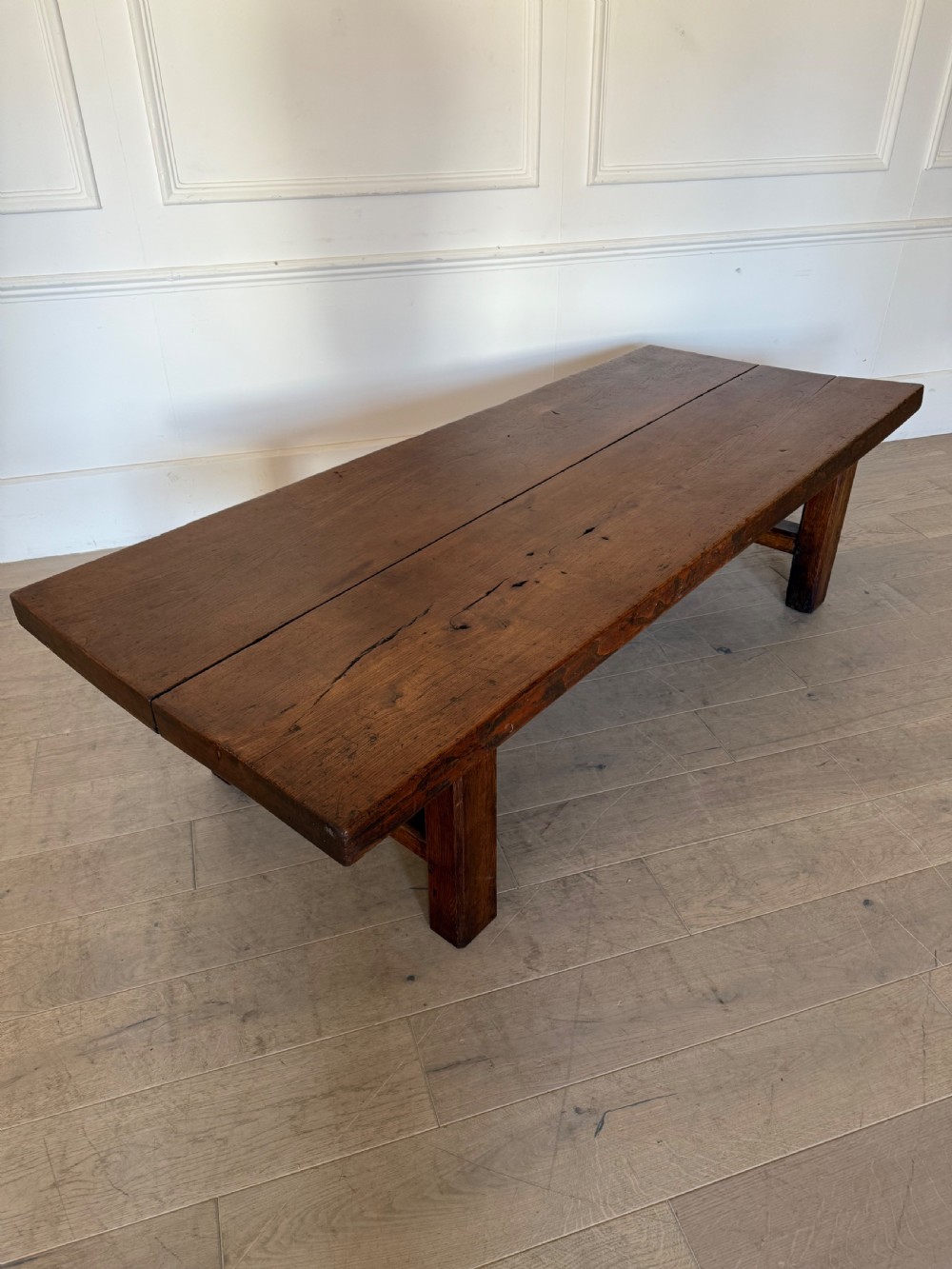 A large rectangular 19th-century elm coffee table with a two-plank top and sturdy wooden legs. View IX