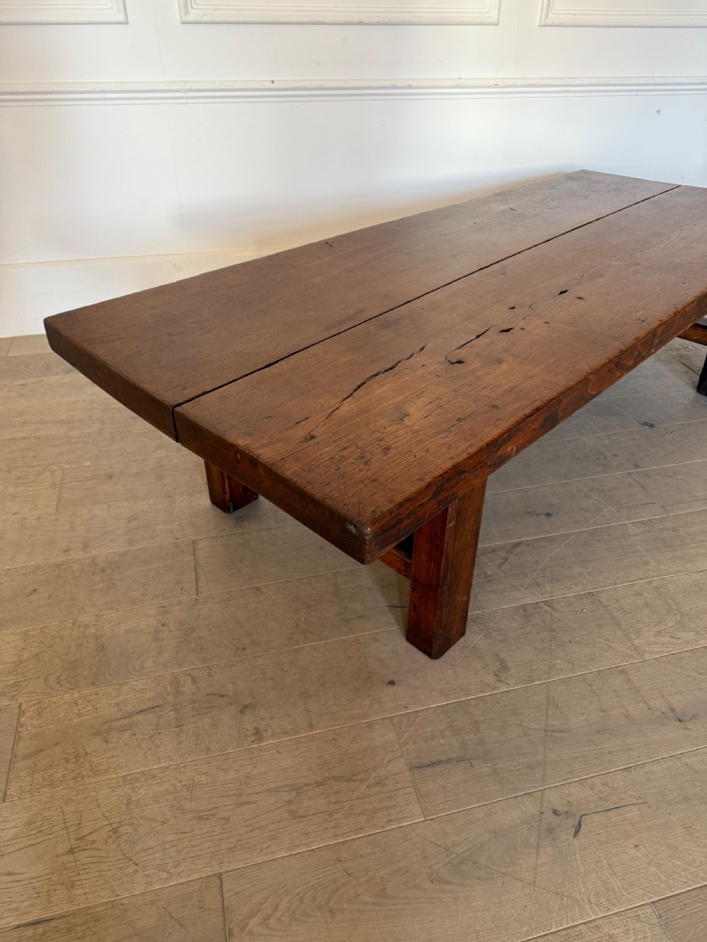 A large rectangular 19th-century elm coffee table with a two-plank top and sturdy wooden legs. View X