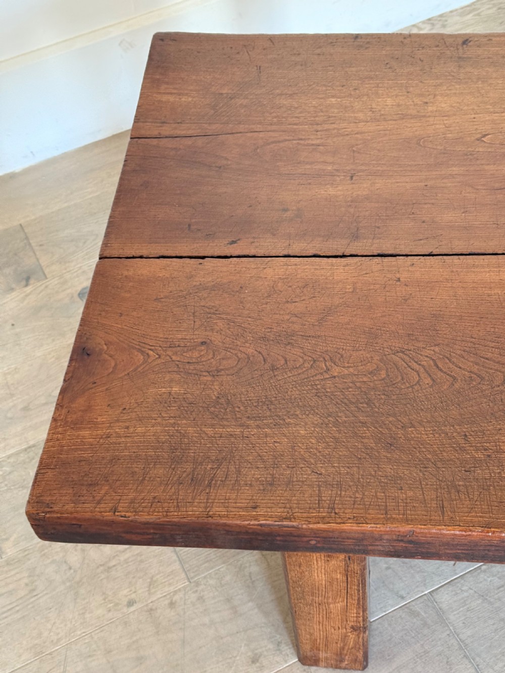 A large rectangular 19th-century elm coffee table with a two-plank top and sturdy wooden legs. View XVI