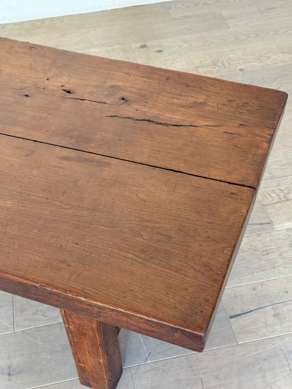 A large rectangular 19th-century elm coffee table with a two-plank top and sturdy wooden legs. View XVIII