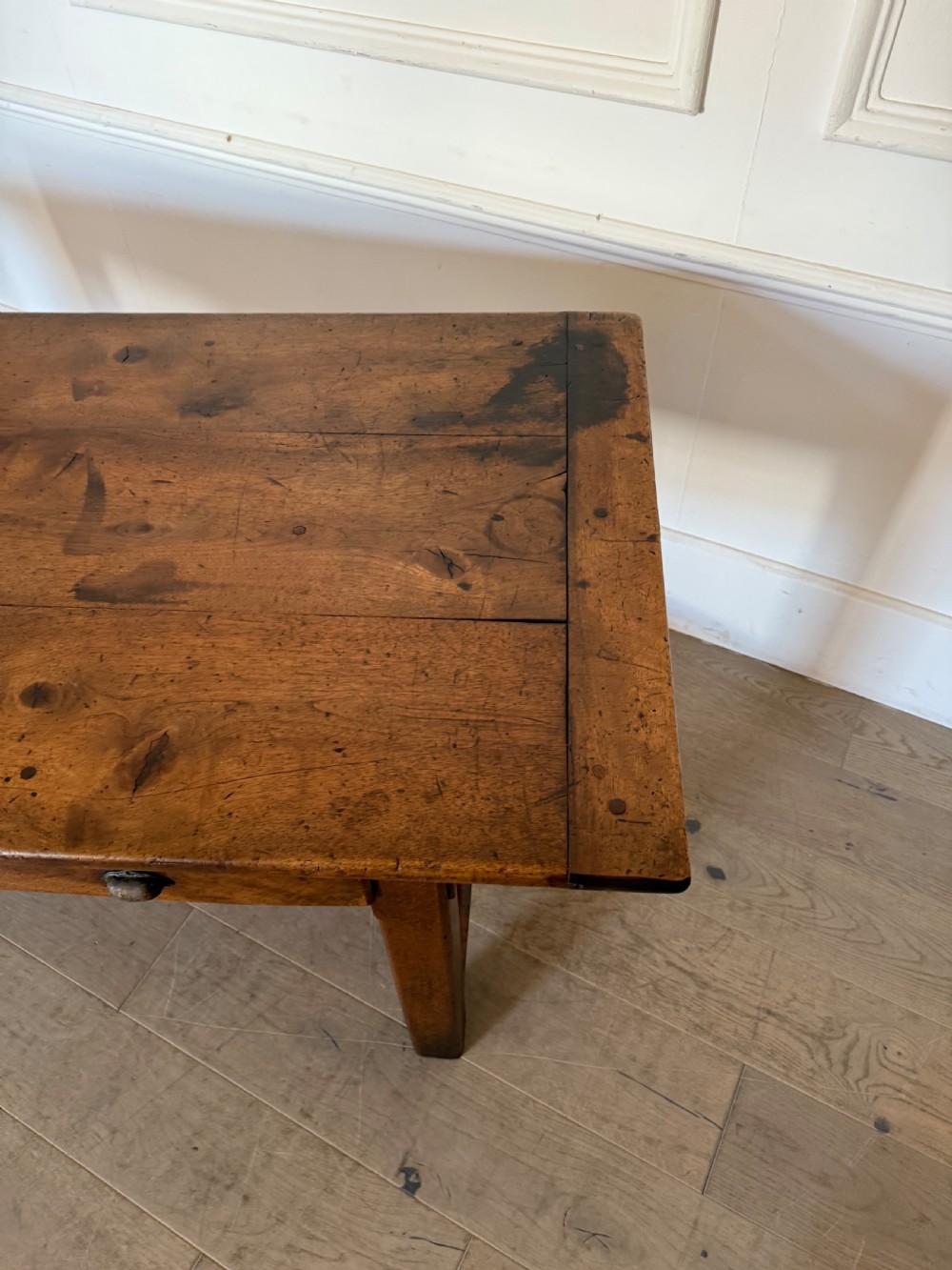 A rectangular 19th-century walnut drapers table featuring a plank top, three drawers with metal drop handles, and an H-stretcher base. View IX