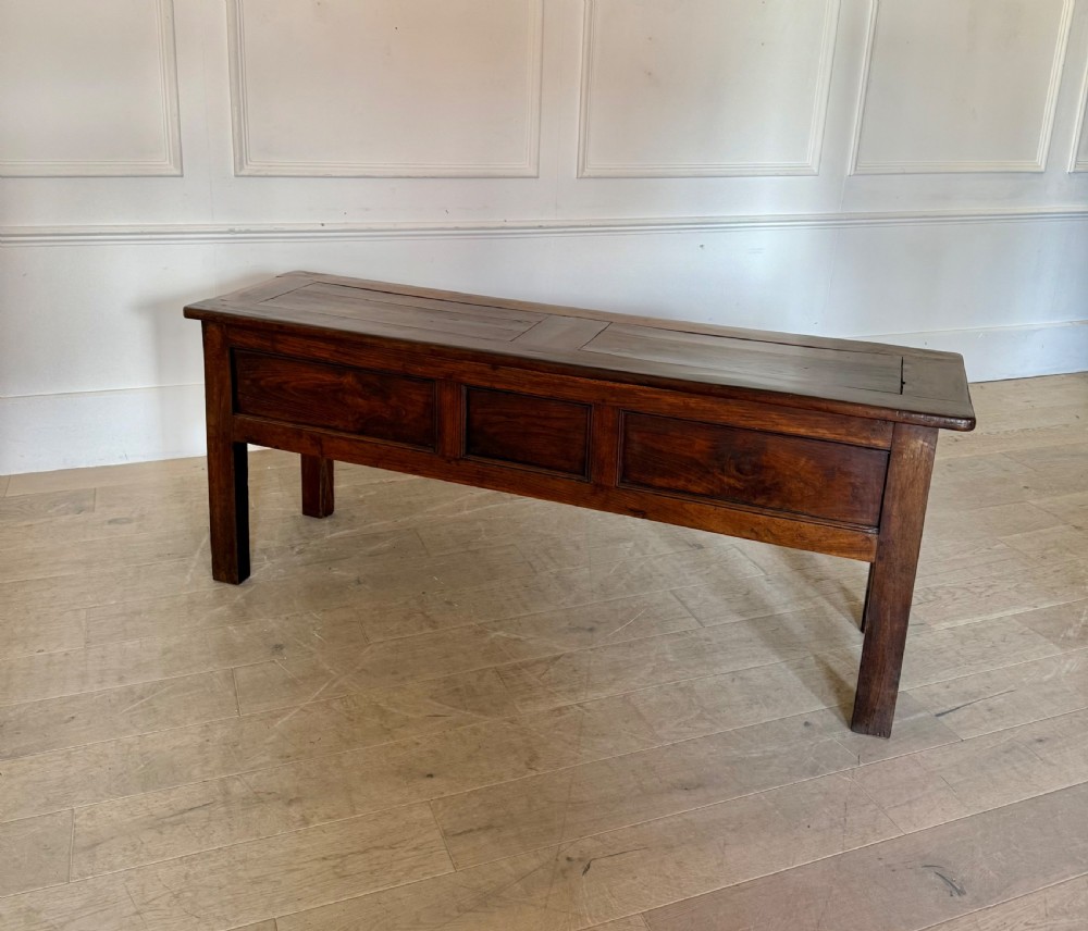A rectangular early 19th-century chestnut dresser base featuring three drawers with turned wooden knobs and straight legs. View XII